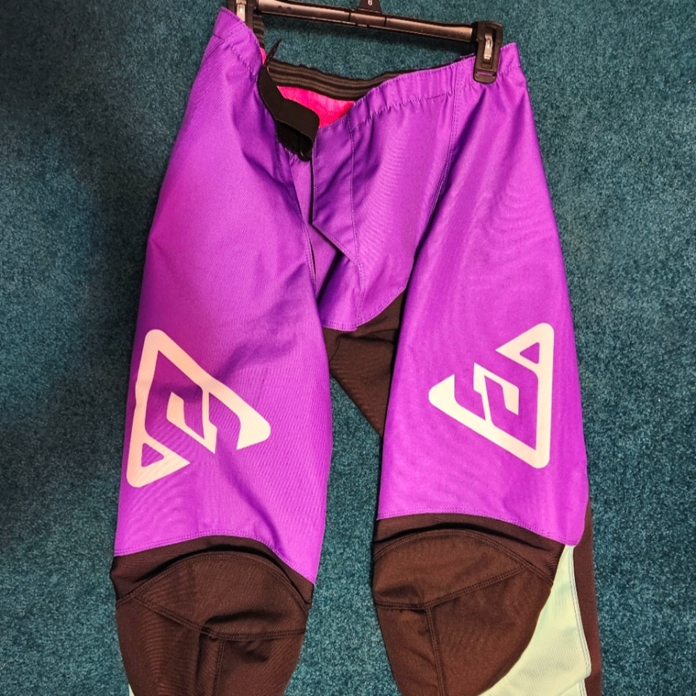 Answer womens motocross pants, size 16. Purple and black, never worn.